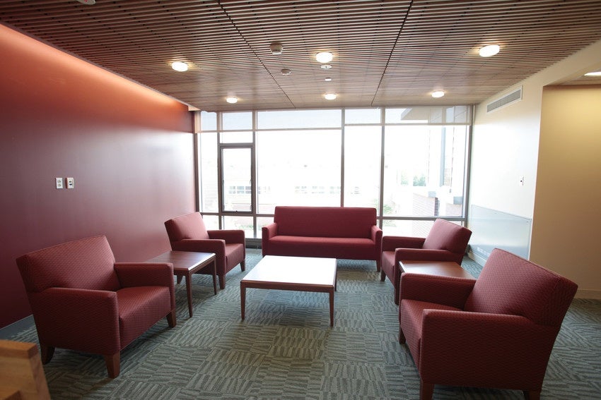 Modern, clean lounge area with padded chairs and a couch.